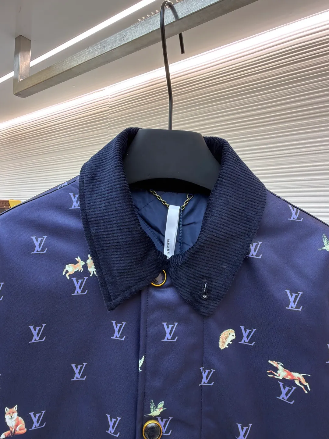 LOUIS VUITTON corduroy lapel animal print jacket ●Original version: 25500 purchased and developed ●Item number: 1681800-C00 ●Fabric: high-density polyester nylon fabric ●Technology: digital direct printing ●Color: blue ●Type: fitted version ●Weight: about 805 grams ●Size: 46-48-50-52 ●Description: This LOUIS VUITTON corduroy lapel jacket is made of high-density twill fabric base, and the surface is combined with corduroy texture splicing, taking into account both stiffness and soft touch. The body pattern uses digital direct printing technology to accurately print the LV logo and animal elements on the fabric. The color is full and not easy to fade. The collar is made of contrasting corduroy material, and the positioning and cutting process is used to ensure the alignment of the splicing; the front placket is equipped with metal buttons, and the surface of the buttons is matte-plated for a refined and durable texture. The version has a loose lapel design, and the shoulders and armholes are three-dimensionally cut, with precise stitching to improve the fit. The overall process pays attention to the details of pattern positioning and fabric splicing. The edges are overlocked to take into account brand recognition and practical wearability. It is recommended to hand wash to protect the printing and fabric texture. The overall wiring is straight and delicate, the fabric is comfortable and soft, and the color is consistent without color difference. It can be matched with the same style to create a fashionable look and control various occasions. Customized accessories, complete with three standards, same style for men and women!